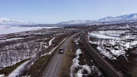Aerial-view-following-truck-driving-on-road-in-the-Swedish-mountains