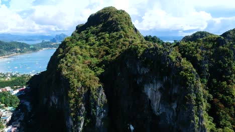 Aerial-arch-over-Taraw-Cliffs-in-El-Nido-Town,-Palawan,-Philippines