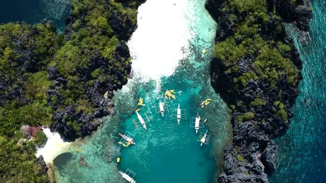 Aerial-top-down-of-boats-outside-of-big-lagoon,-small-lagoon,-El-nido,-Palawan,-Philippines