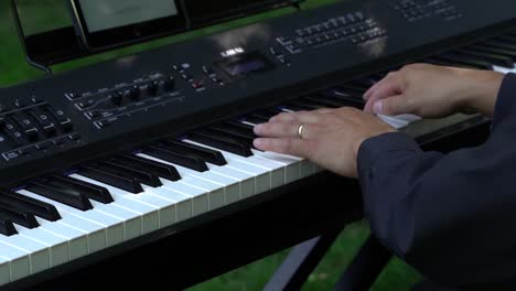 Close-Up-of-Wedding-Pianist's-Hands-playing-Keyboard-at-Outdoor-Wedding-in-Slow-Motion