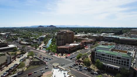 Aerial-pull-back-from-the-intersection-of-Scottsdale-and-Camelback-road-to-reveal-the-valley-of-the-sun,-Scottsdale,-Arizona