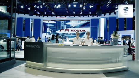 Honda-Representatives-standing-behind-the-Information-Desk-at-2019-International-Auto-Show-in-Shenzhen,-China