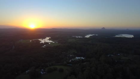 Aerial-drone-shot-of-Australia's-landscape-with-forests,-lake,-mountain-and-beautiful-sunset