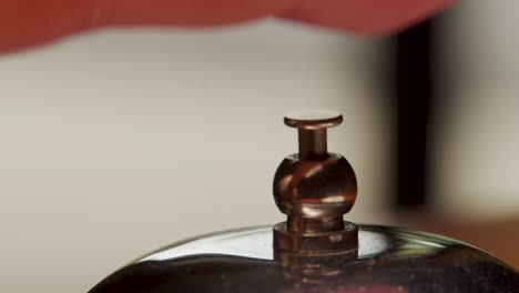 Hotel-desk-bell-with-finger-triggering-the-bell