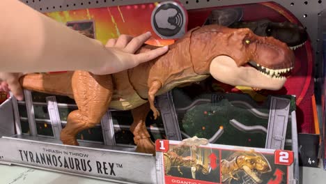 Hand-playing-with-a-Thrash-N'-Throw-T-Rex-toy-at-a-local-Target-store