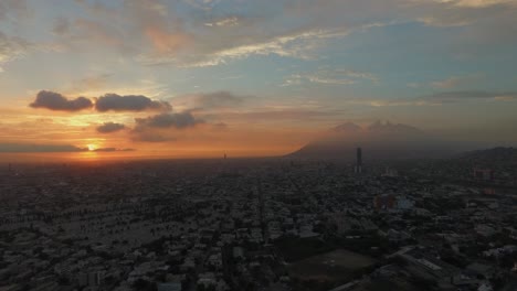 Aerial-wide-drone-shot-of-the-sunrise-in-Monterrey,-Mexico