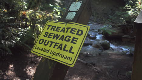 Sign-warning-about-treated-sewage-in-a-forest