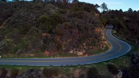 Tight-Curve-of-Mountain-Road-beside-Steep-Cliff-at-Dawn,-Drone-Reveal