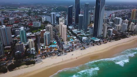 Aerial-view-of-a-modern-skyscraper-city-by-the-beach-on-a-cloudy-day