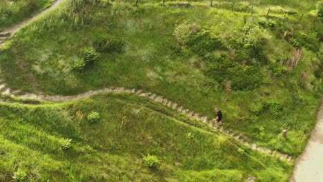 An-athletic-man-running-up-steps-on-a-countryside-path