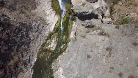 Top-down-aerial-drone-shot-of-Paradise-Falls,-waterfall-birdseye-view-of-water-pouring-down