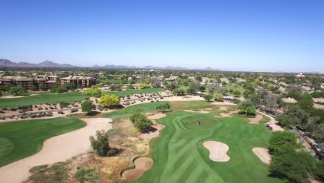 Aerial-high-angle-of-a-foursome-on-the-green,-Scottsdale-Arizona