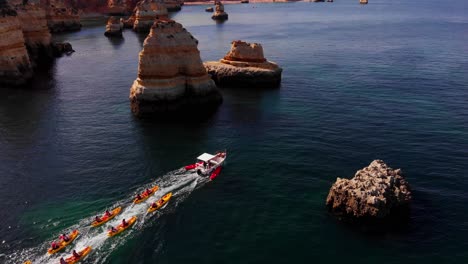 The-perfect-kayak-experience-as-boat-pulls-kayaks-through-epic-canyon-landscapes
