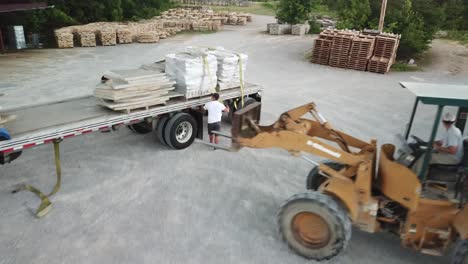 Building-stone-loaded-onto-a-truck-with-a-forklift