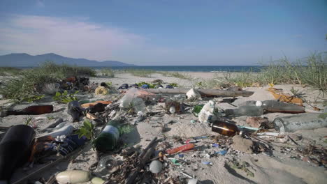 Miscellaneous-waste-of-domestic-plastic,-bottles,-and-fishing-equipment-trash-pollute-white-sandy-beach