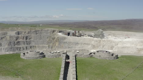 An-aerial-view-of-the-Coldstones-Cut-public-artwork-near-Pateley-Bridge-with-an-asphalt-quarry-in-the-background