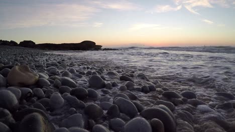 Early-morning-waves-breaking-onto-pebble-beach