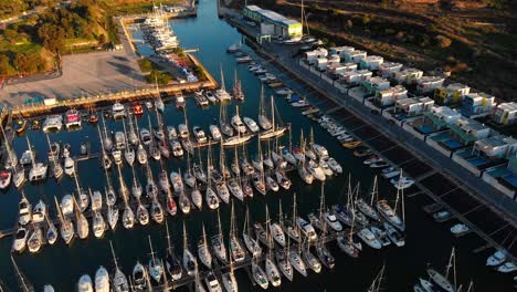 Aerial-shot-over-sailing-boats-golden-hour-sailing-club-in-the-ocean
