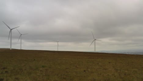 Slow-spinning-wind-turbines-shot-from-a-drone