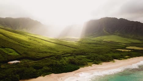 4K-Drone-shot-smoothly-panning-over-Makua-Valley-on-Oahu-as-the-sun-rays-peak-over-the-mountains-and-light-up-the-valley