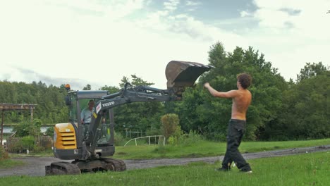 Digger-arm-lowering-young-fit-man-after-doing-body-weight-training-outdoors