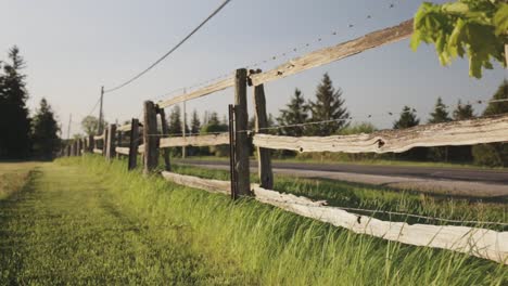Rack-focus-of-a-wooden-fence-on-the-countryside