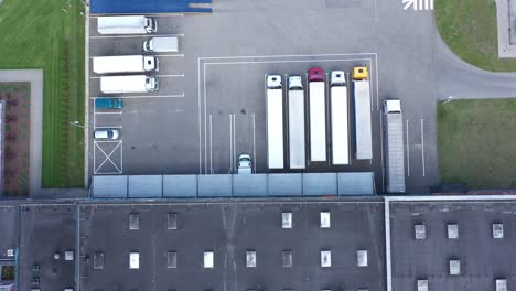 Aerial-view-of-the-logistics-warehouse-with-trucks-waiting-for-loading