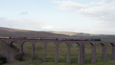Aerial-Tracking-Shot-of-the-Flying-Scotsman-60103-Steam-Train-as-it-Passes-Over-Ribblehead-Viaduct-in-North-Yorkshire-with-Wide-Crop