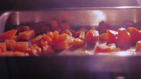 Grilling-butternut-in-oven,-panning-shot