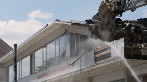 Demolition-machine-tearing-down-roof-of-a-condemned-building
