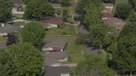drone-flyover-ranch-houses-in-suburbs-towards-a-bus-driving-across-the-frame