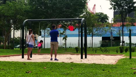 Parents-with-their-children-in-a-playground,-Singapore,-12-Jun-19