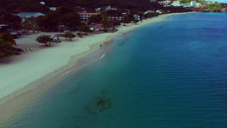 Drone-footage-of-the-most-amazing-beach-in-Grenada-with-resorts-lining-the-shoreline,-Grand-Anse-Beach