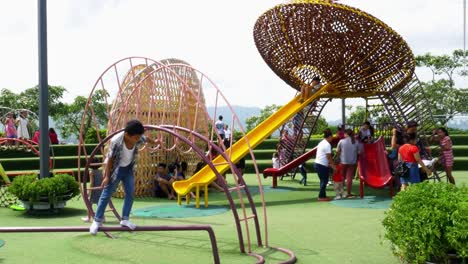 Supervised-by-parents-and-guardians,-frolicking-young-kids-explore-the-playground-attractions-at-SM-Seaside-Mall-on-South-Road-Properties,-Cebu-City,-Philippines