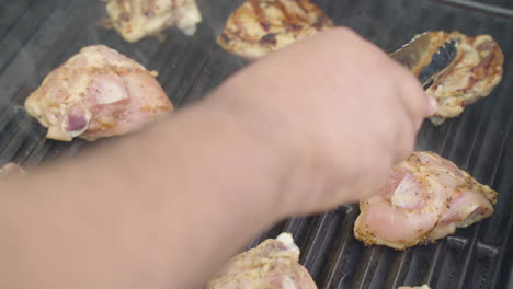 Flipping-chicken-breasts-on-a-barbecue-revealing-grill-marks