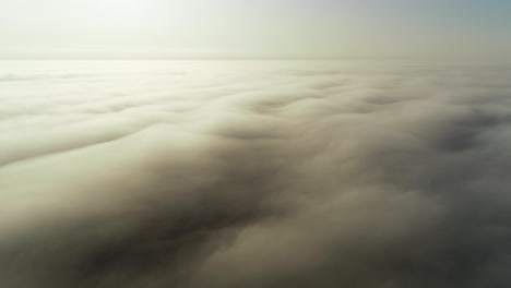 Flight-above-clouds-in-morning-golden-hour