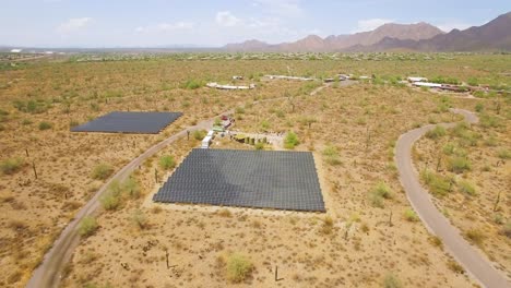 Aerial-push-in-on-an-array-of-solar-panels-in-the-Sonoran-desert-near-Taliesin-West,-Scottsdale,-Arizona-Concept:-environment,-alternative-energy,-solar-power