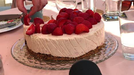 Cutting-strawberry-cake-outside-with-silver-knife