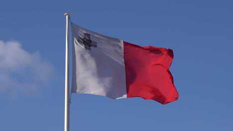 Waiving-Malta-Flag-in-slow-motion-on-clear-blue-sky---static-shot