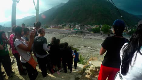 Himalayan-mountaineers-on-their-way-to-the-trail,-enjoying-the-beautiful-view-of-the-Holy-river-Ganges