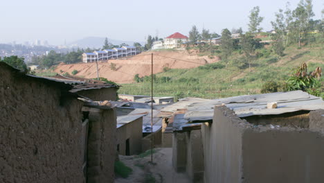 Tilt-down-to-row-of-homes-in-a-slum-neighborhood-outside-Kigali,-Rwanda