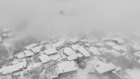 Aerial-footage-over-snowy-mountain,-traditional-village-in-Greece-11