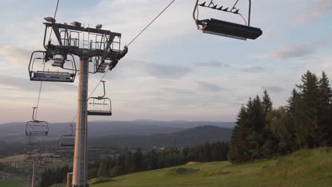 Closed-ski-lift-in-the-summer,-low-angle-shot-with-panorama