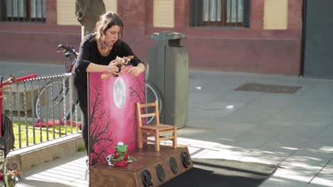 Young-woman-putting-on-a-puppet-show-on-the-streets
