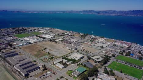 4k-aerial-drone-view-of-treasure-island-san-francisco-bay-area-surrounded-by-turquoise-blue-ocean-sea-water-waves-camera-move-forward-inside