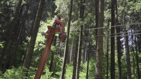 Kleines-Mädchen-Mit-Roten-Haaren-Auf-Einem-Holzfahrrad-Im-Abenteuerpark-In-Den-Italienischen-Alpen-Zeitlupe-100fps