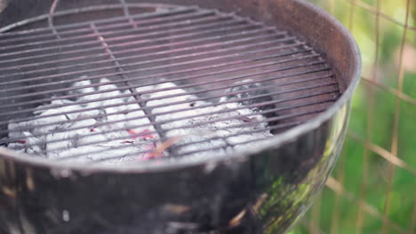 Slow-Motion-of-Empty-Smokey-BBQ-Grill-With-Coals