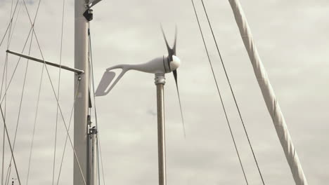 Wind-Turbine-on-a-boat,-showing-you-the-turbine-moving-around-in-the-wind
