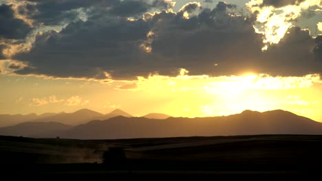 Mähdrescher-Im-Ländlichen-Colorado,-Vor-Dem-Hintergrund-Der-Berge-Und-Des-Sonnenuntergangs