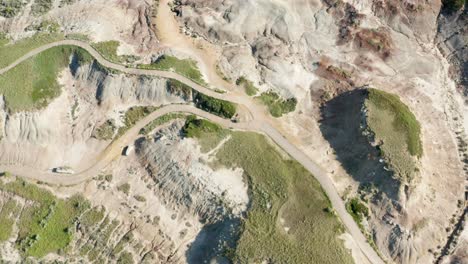 Top-down-aerial-view-over-badlands-in-Alberta,-Canada